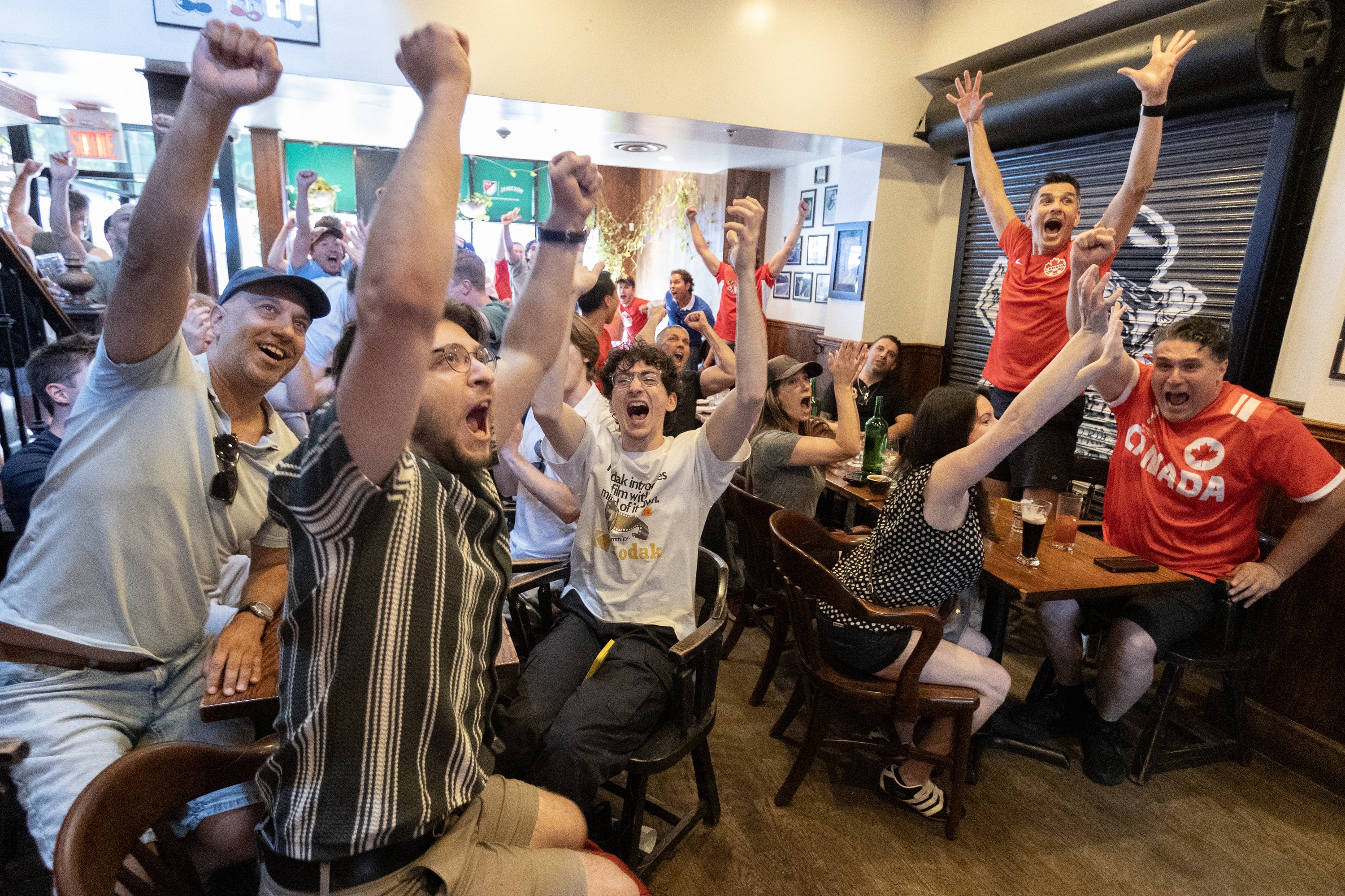 Fans at Montreal's Burgundy Lion pub react as Canada scores during the World Cup match against South Africa