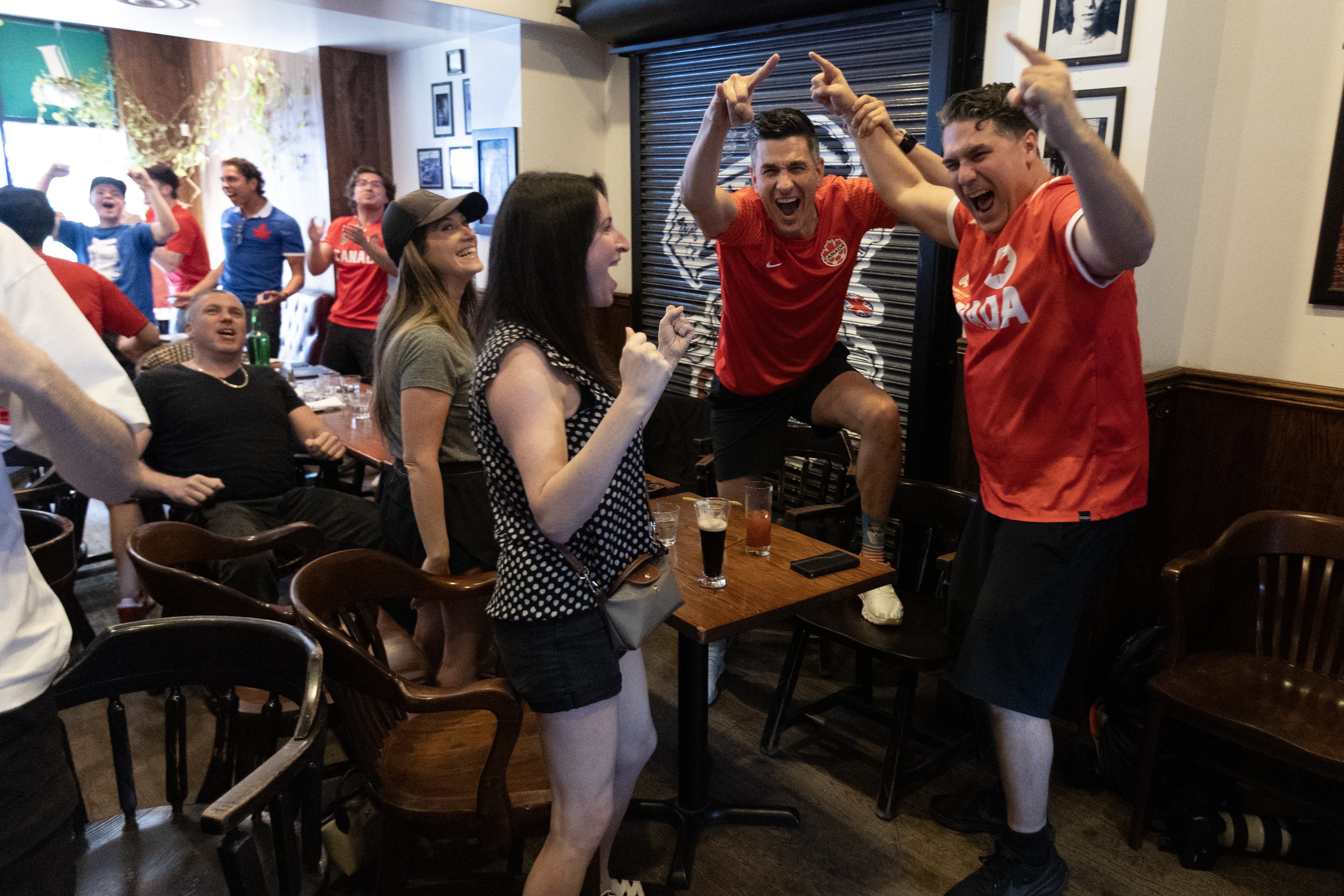 Fans at Montreal's Burgundy Lion pub react as Canada scores during the World Cup match against South Africa