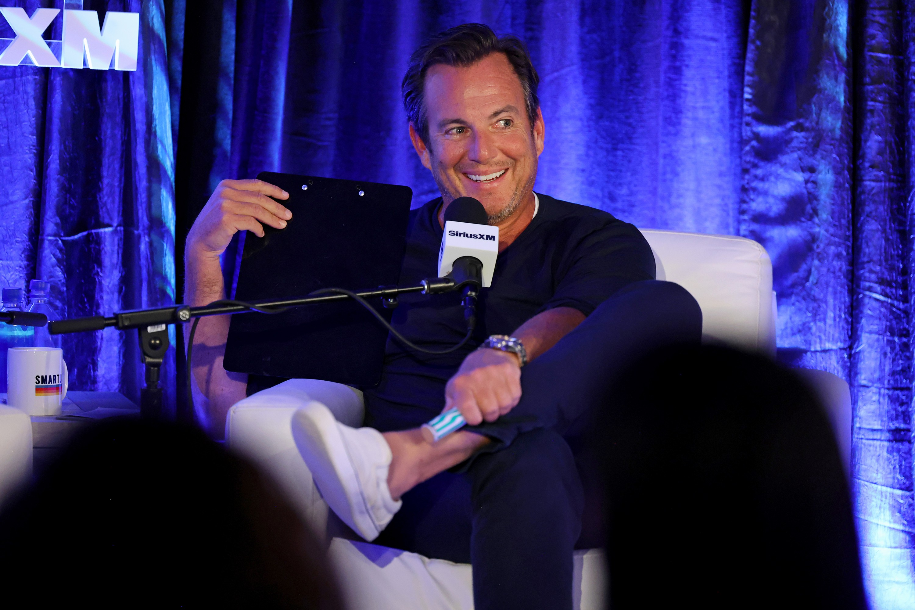 Will Arnett smiles as he faces a SiriusXM microphone