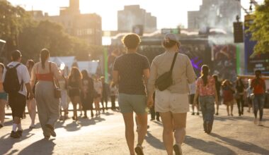People walk toward a city skyline