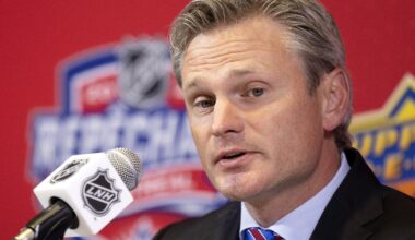 Nick Bobrov, co-director of amateur scouting for the Montreal Canadiens, speaks into a microphone with the French branding of the NHL