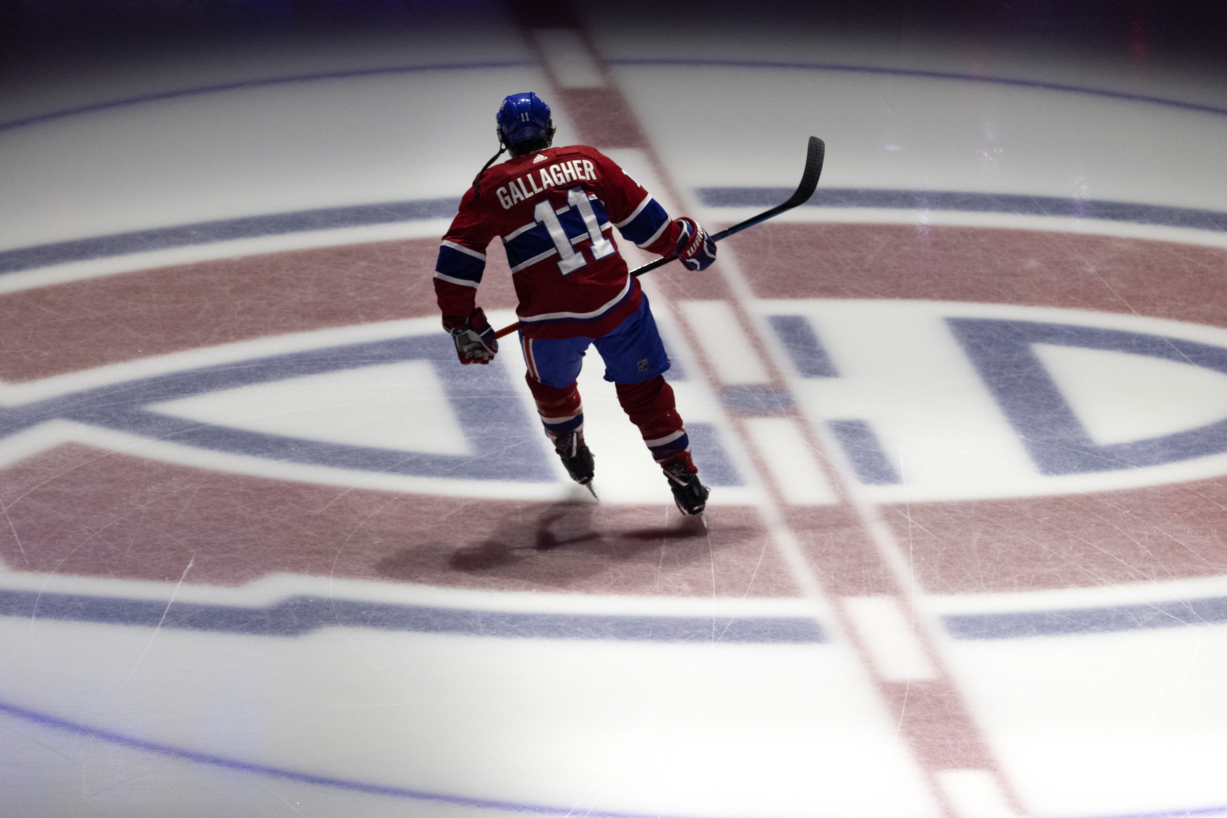 Brendan Gallagher skates alone across the Canadiens logo at centre ice.