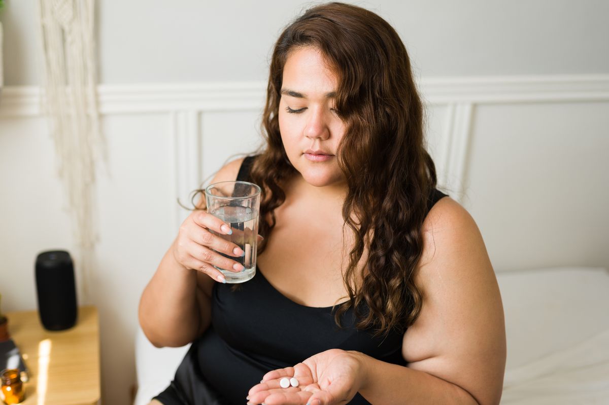 Woman taking tablet
