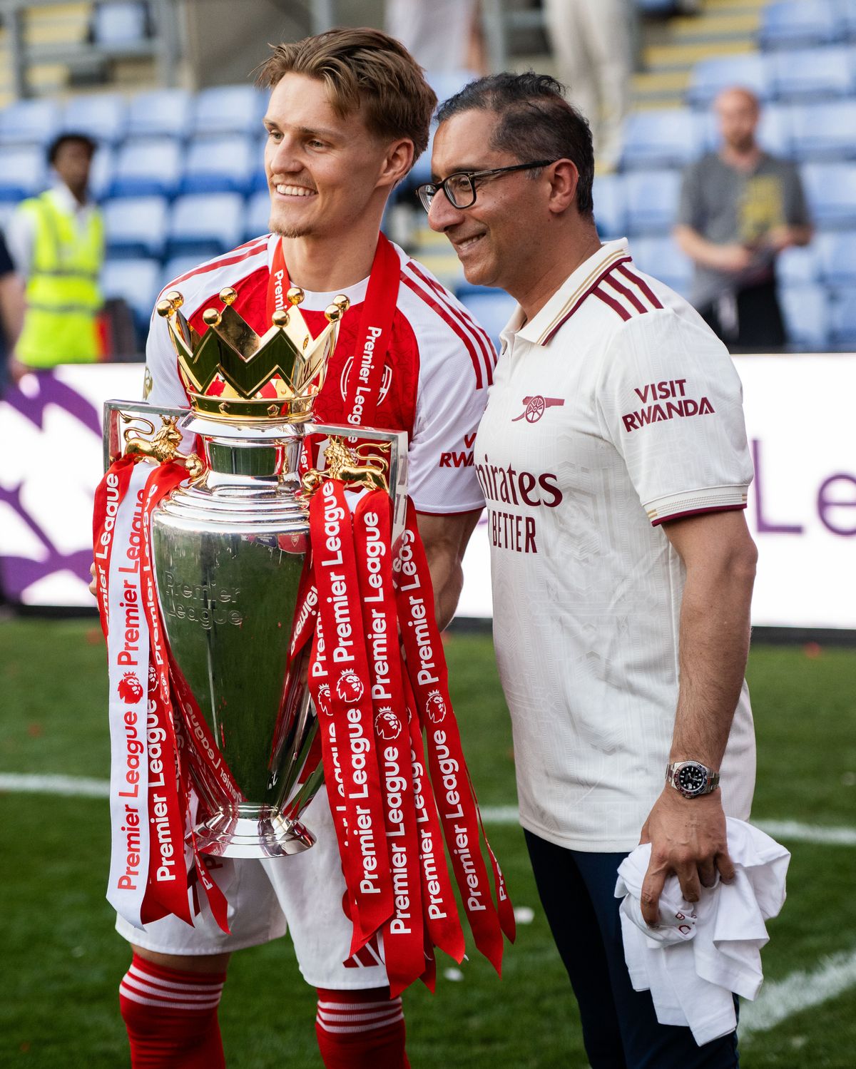 Martin Odegaard and club doctor Zafar Iqbal of Arsenal FC with a trophy during the Premier League match between Crystal Palace and Arsenal at Selhurst Park on May 24, 2026 in London, United Kingdom