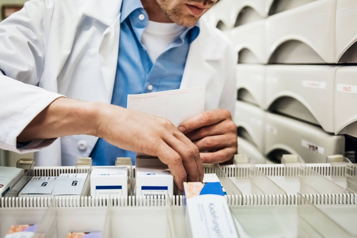 Pharmacist Finding Prescription For A Customer