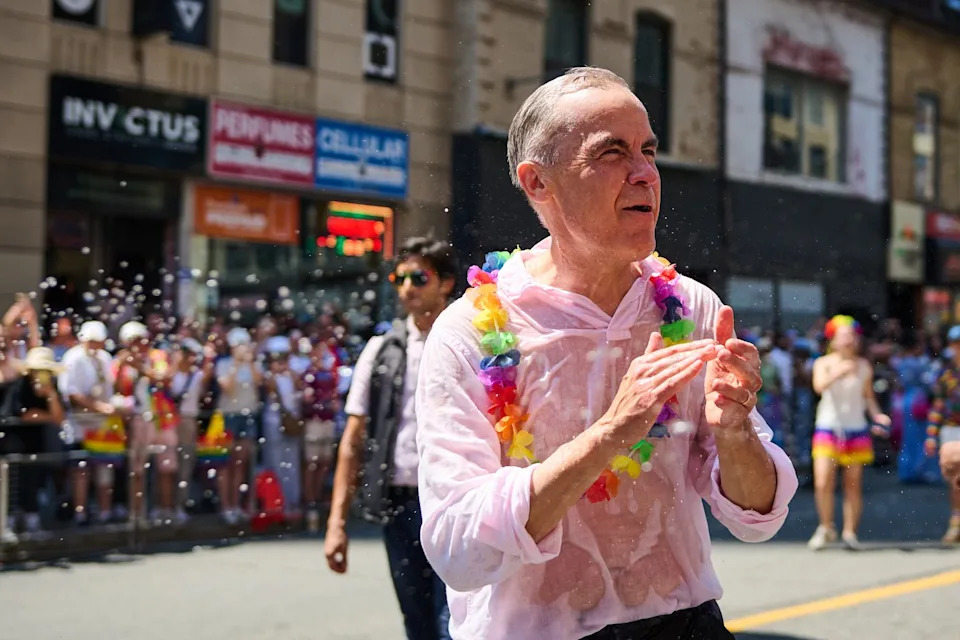 Prime Minister Mark Carney is sprayed with water as he takes part in the Toronto Pride Parade on Sunday, June 28, 2026. THE CANADIAN PRESS/Sammy Kogan