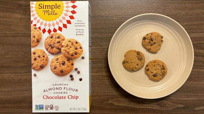 Simple Mills Chocolate Chip Crunchy Cookies box and gluten-free cookies on brown plate