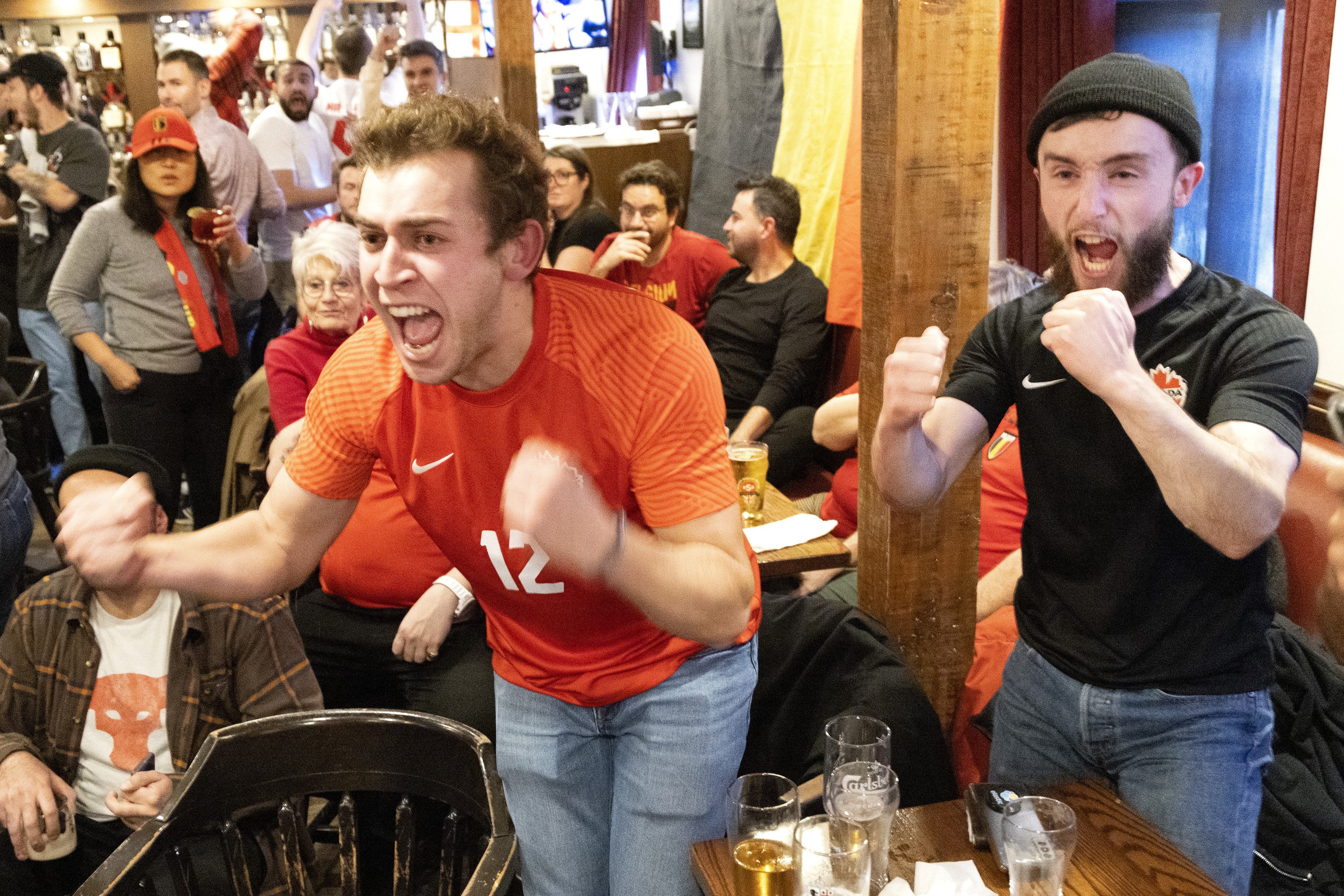 Canada fans cheer while watching a World Cup match in 2022 at the Burgundy Lion in Montreal.