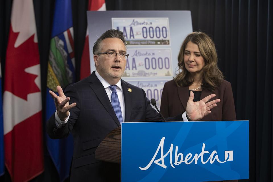Minister of Service Alberta and Red Tape Reduction Dale Nally, left, with Alberta Premier Danielle Smith, announces a voting period for Alberta's new licence plates in Edmonton, on Wednesday, Oct. 15, 2025. The new plate will include the phrase "Strong and Free", which is also used by the United Conservative Party. THE CANADIAN PRESS/Amber Bracken - The Canadian Press