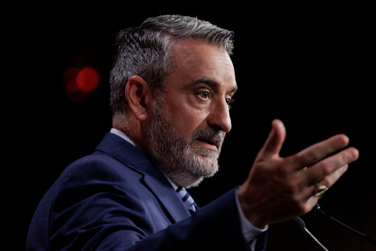 A man speaks at a news conference.