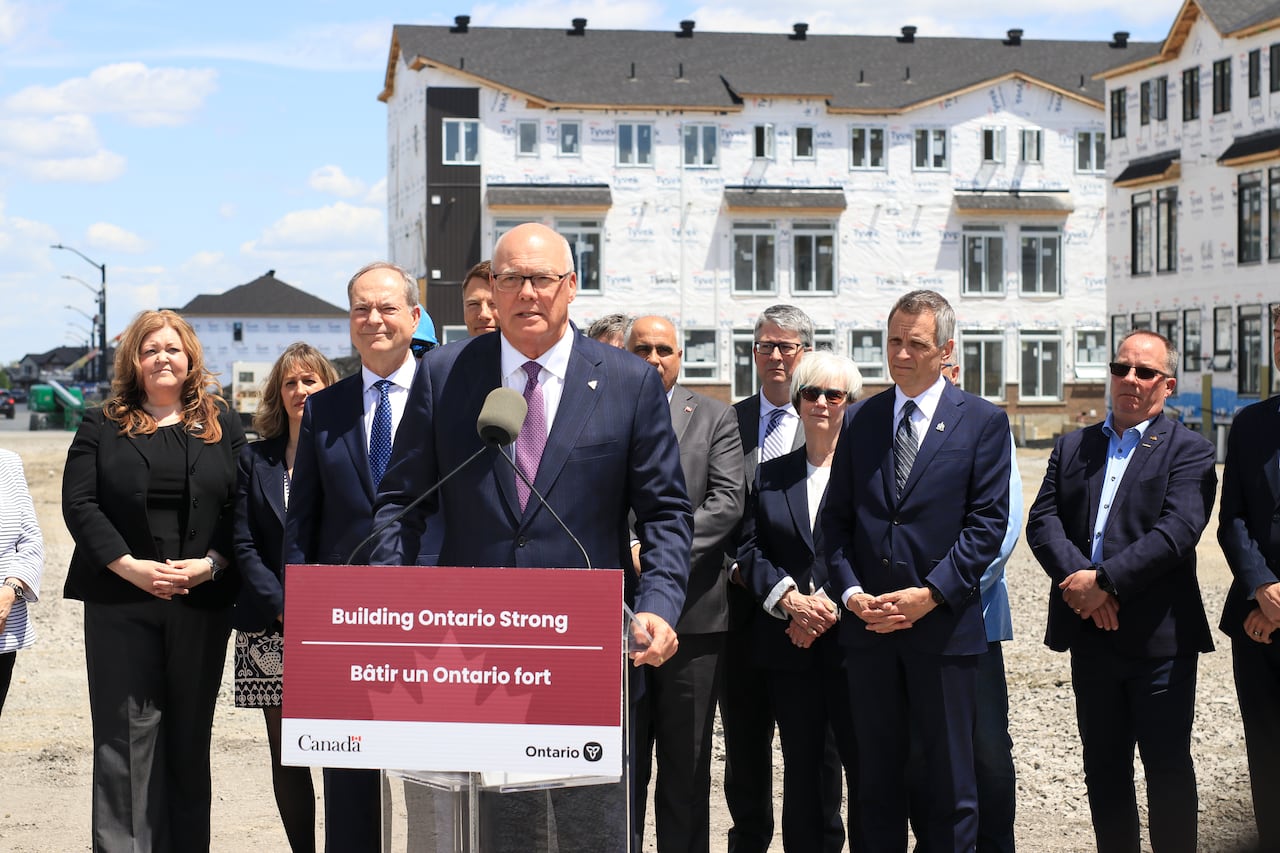 A row of politicians at a press conference