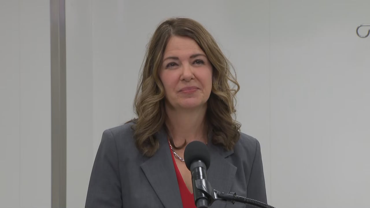 A woman is pictured in a suit at a news conference.