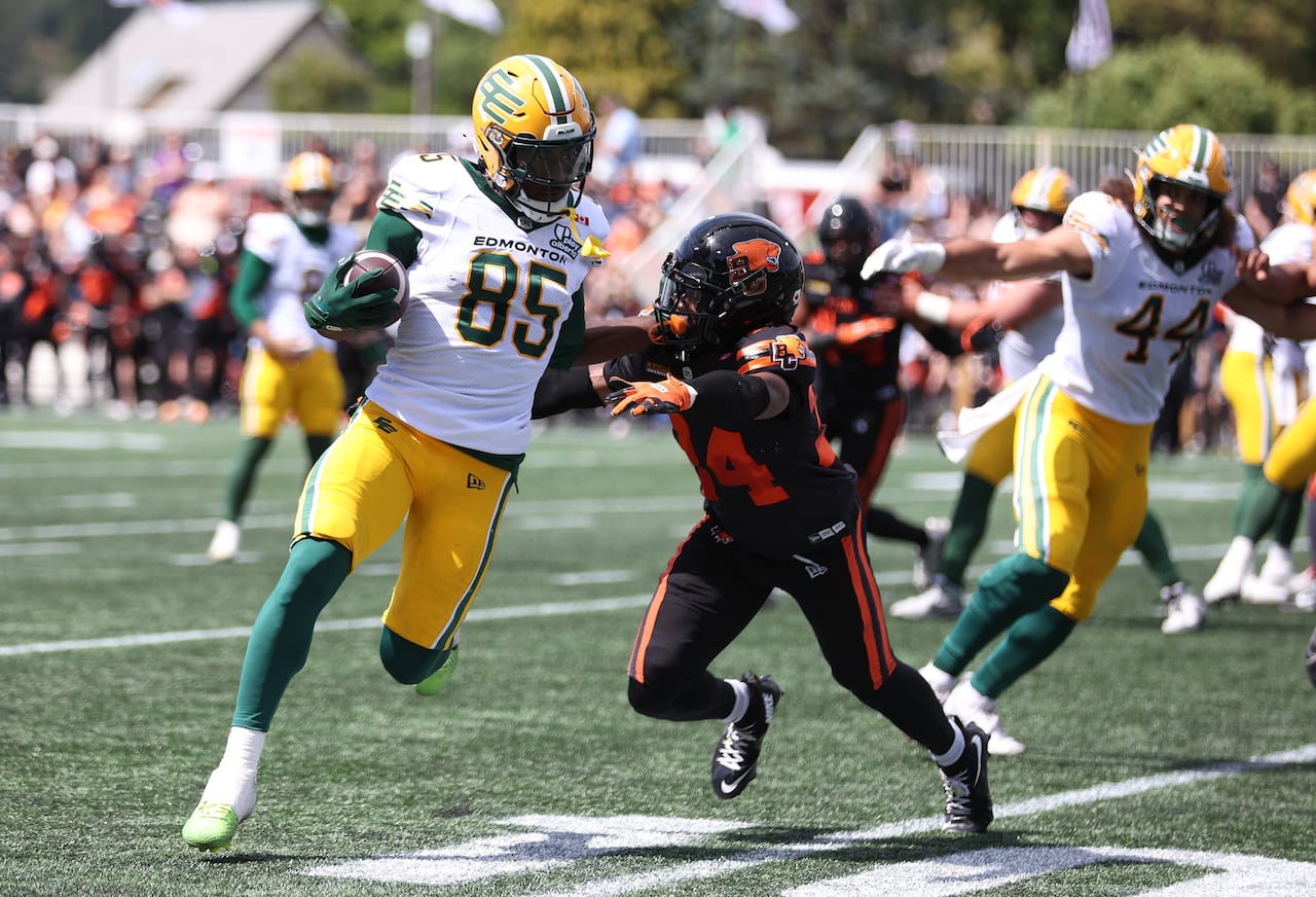 B.C. Lions' Zander Horvath, right, looks to tackle Edmonton Elks' Jalon Calhoun during first half of preseason CFL football action in Langford, B.C., on Saturday, May 23, 2026.