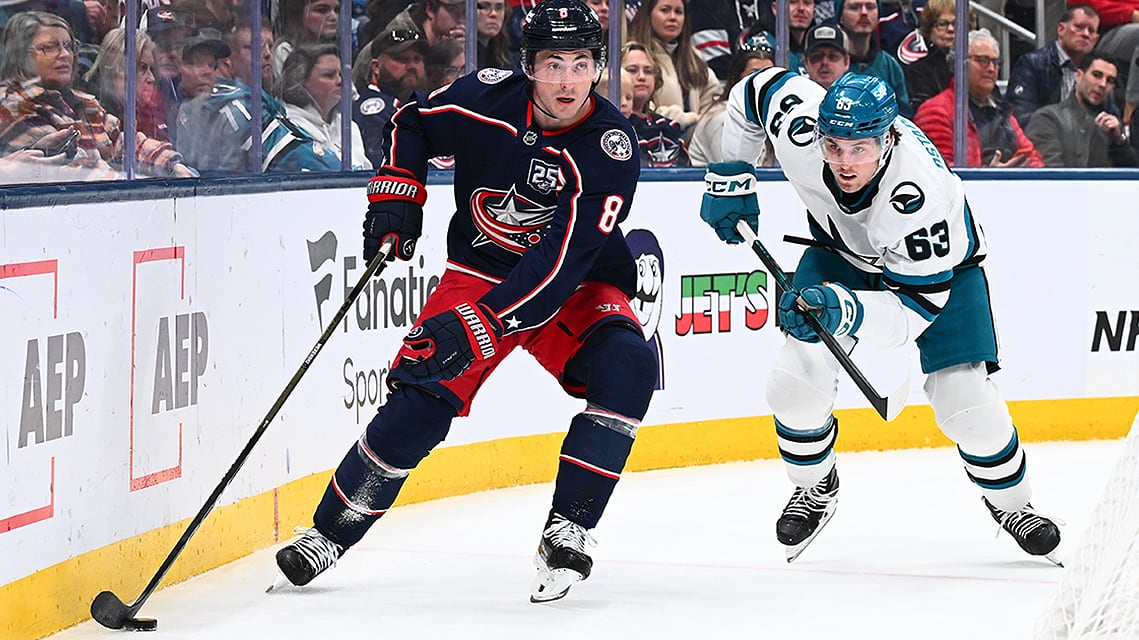 Columbus Blue Jackets defenceman Zach Werenski skates with the puck as Zack Ostapchuk #63 of the San Jose Sharks defends in the second period of a March 28, 2026 NHL regular-season game at Nationwide Arena in Ohio.
