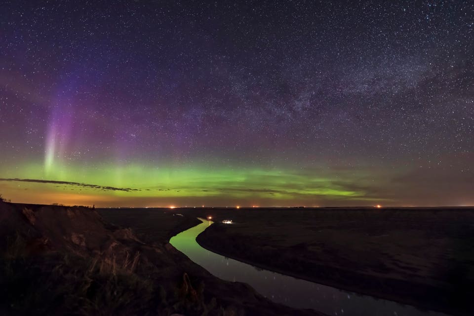 A faint aurora along the northern horizon and the summer Milky Way rising in the northeast