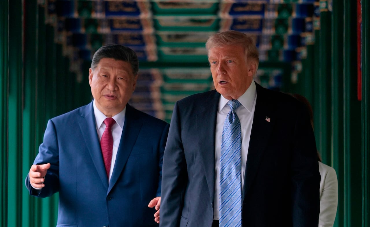 U.S. President Donald Trump, right, participates in a friendship walk through Zhongnanhai Garden with Chinese President Xi Jinping