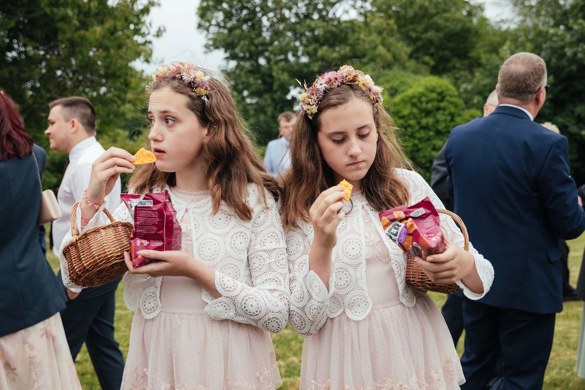 Twin Bridesmaids Enjoy Canapés, Devon, UK