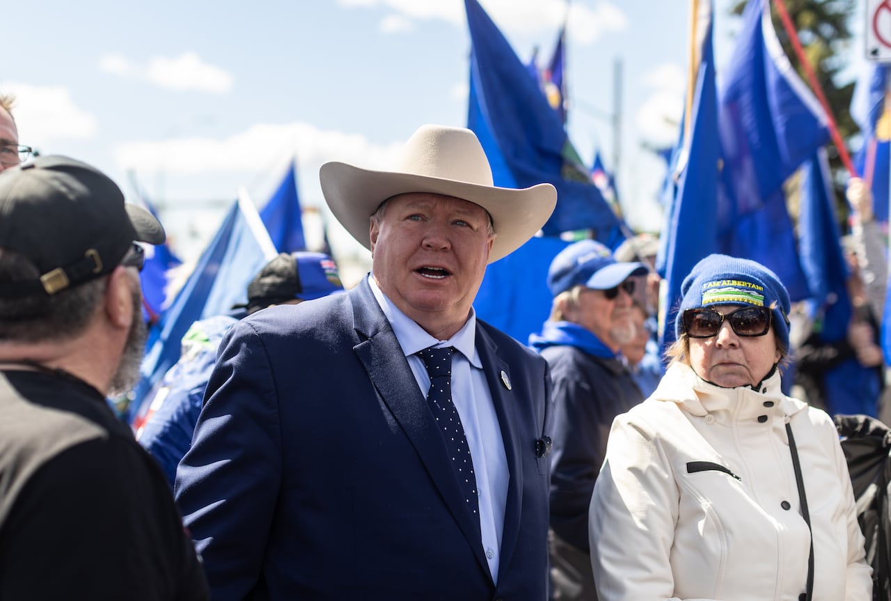 A man wears a cowboy hat.