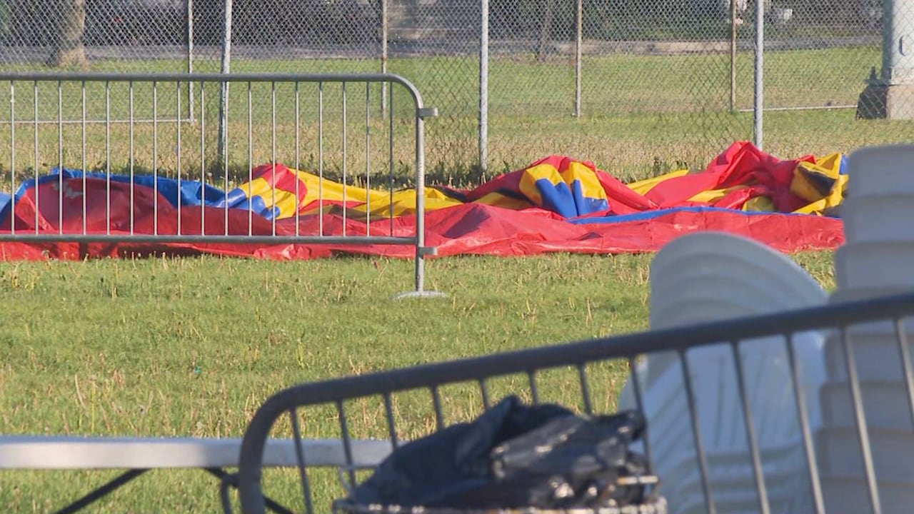 A deflated bouncy castle on the grass.
