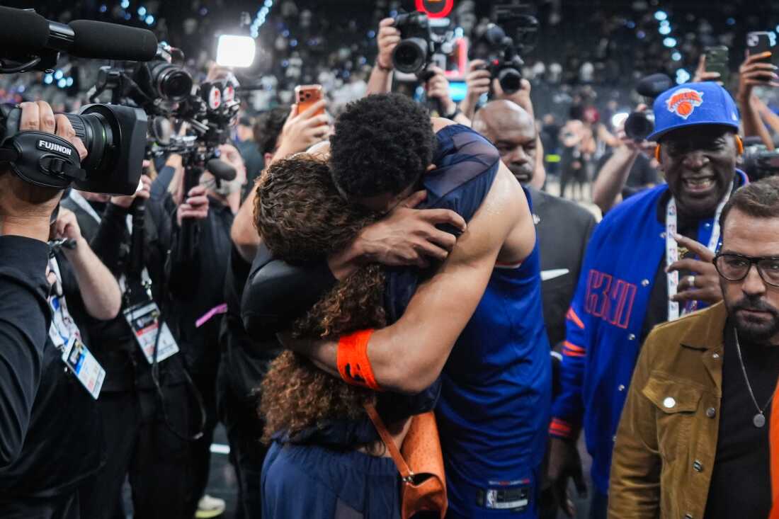 New York Knicks center Karl-Anthony Towns is embraces as he leaves the court after Game 2 of the NBA Finals basketball series against the San Antonio Spurs, Friday, June 5, 2026, in San Antonio.