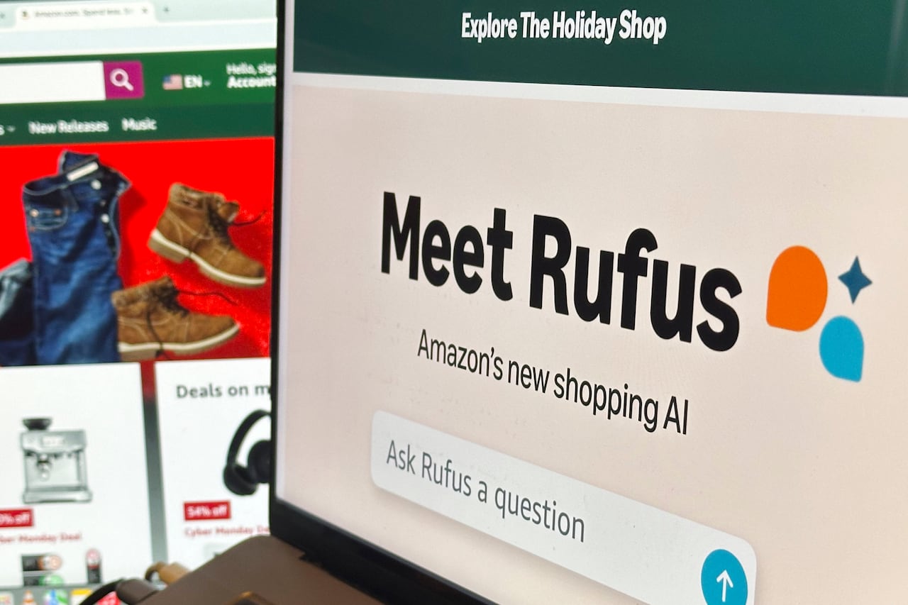 a chatbot interface on a laptop screen reads "Meet Rufus, Amazon's new shopping agent" with a search bar underneath that says "Ask rufus a question."