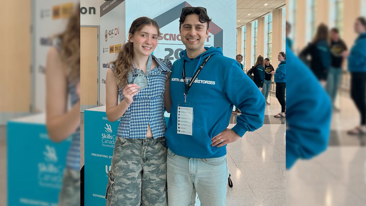 Luna Langlois poses with her silver medal from the Skills Canada photography competition, alongside teacher Nikita Morozov.