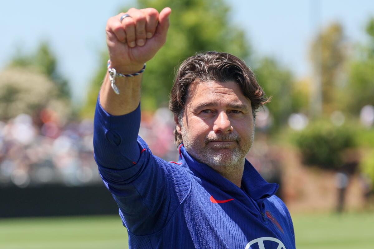 U.S. men's national soccer team coach Mauricio Pochettino waves to fans attending practice on Monday.