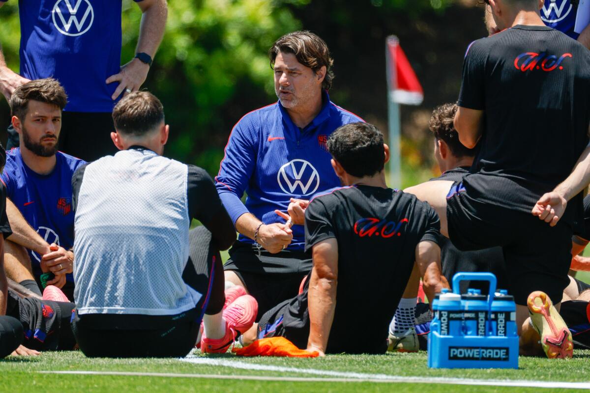 U.S. coach Mauricio Pochettino speaks to players after