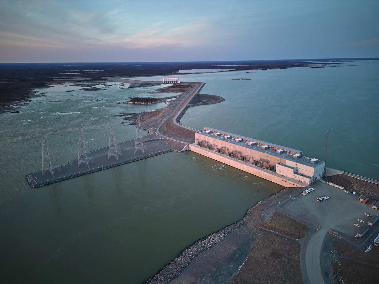 An aerial view of a hydro-electric dam, spillway and reservoir.