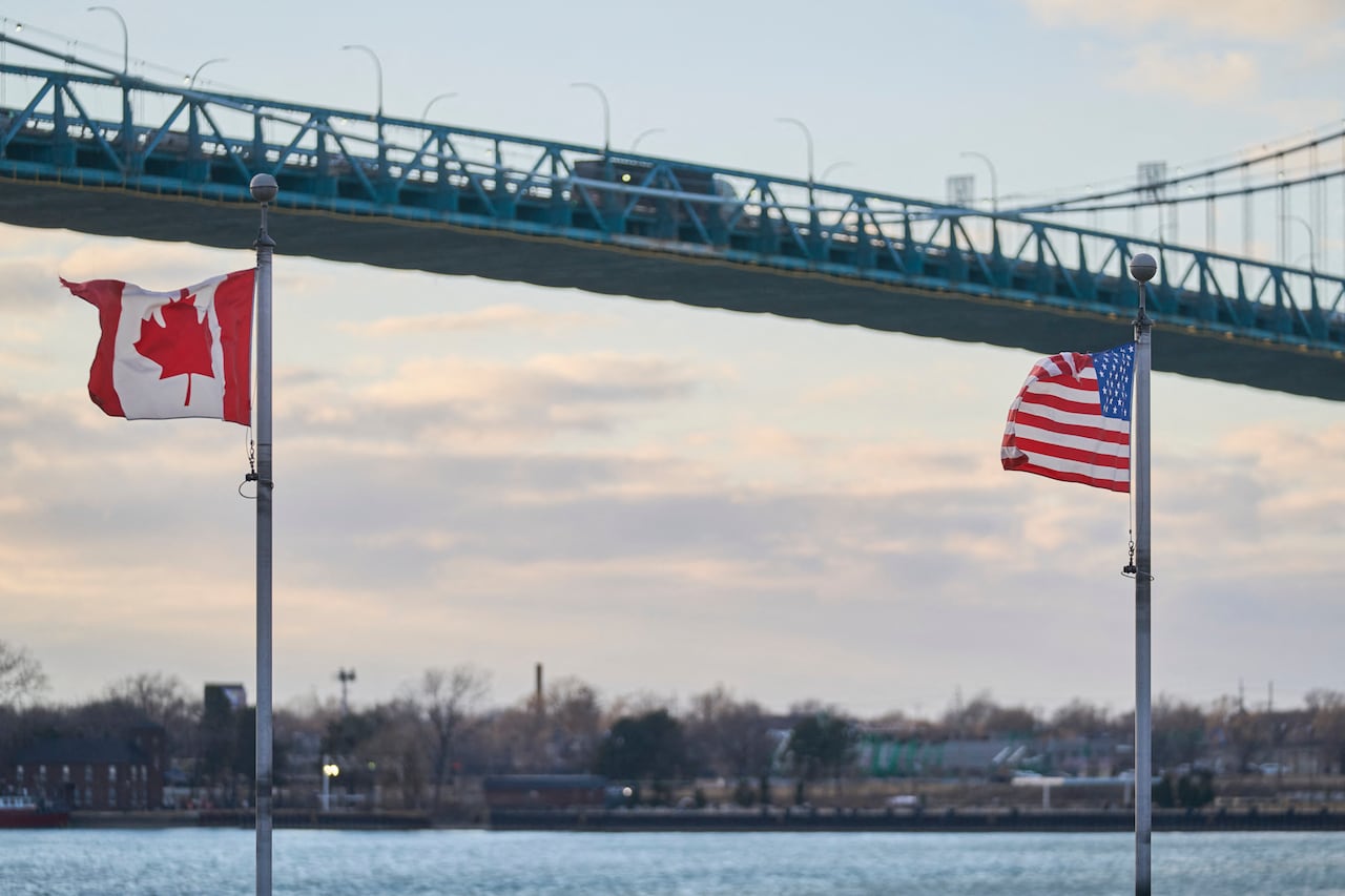 A truck crosses the Ambassador Bridge, border crossing between Windsor, Ontario, Canada, and Detroit, Michigan, above the Canadian Vietnam Veterans Memorial on March 1, 2025.
