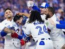 Brandon Valenzuela of the Toronto Blue Jays is mobbed by his teammates after hitting a walk-off RBI single to defeat the Philadelphia Phillies during the ninth inning in their MLB game at the Rogers Centre on June 9, 2026 in Toronto.