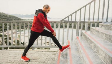 Senior man warming up body and legs in morning before jogging. Healthy lifestyle in old age. Active grey-haired senior on retirement.