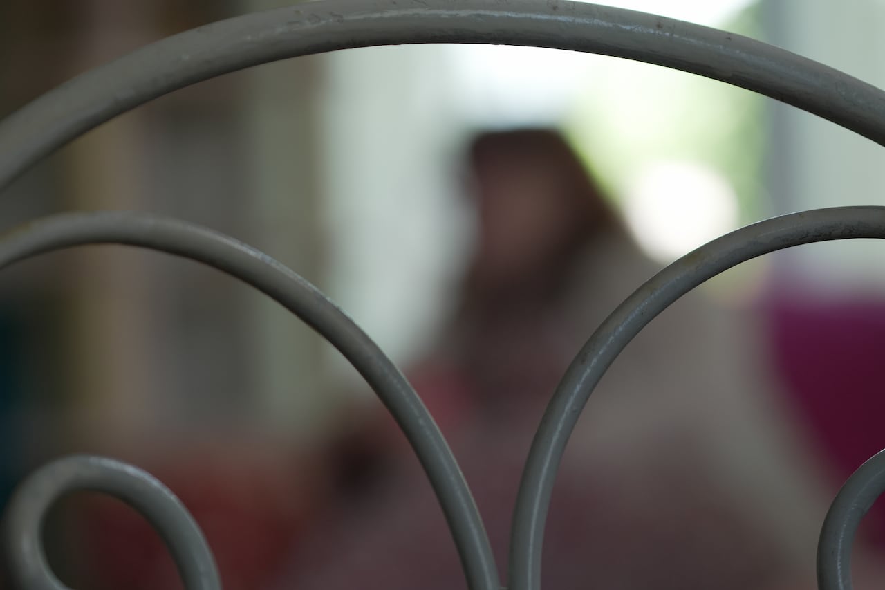 blurred image of a woman behind a chair