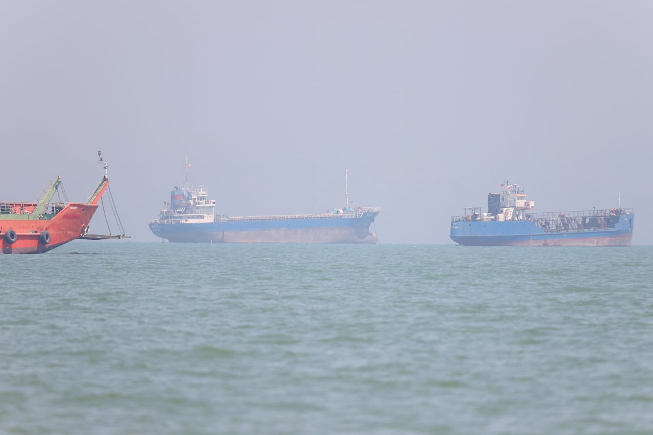 Three ships seen on a body of water from afar.