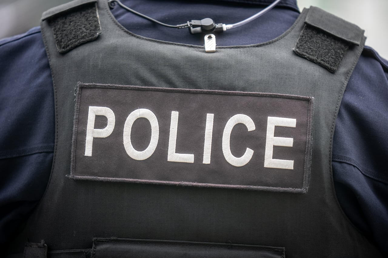 Close up image of a police vest with the word POLICE on it.