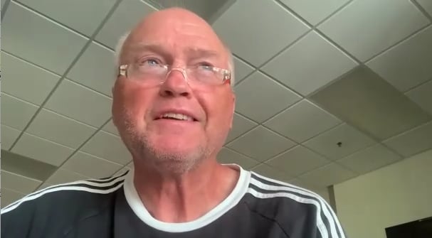 A man speaks on a Zoom call.