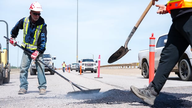 Frustrated Fort McMurray residents fill Highway 63 potholes themselves
