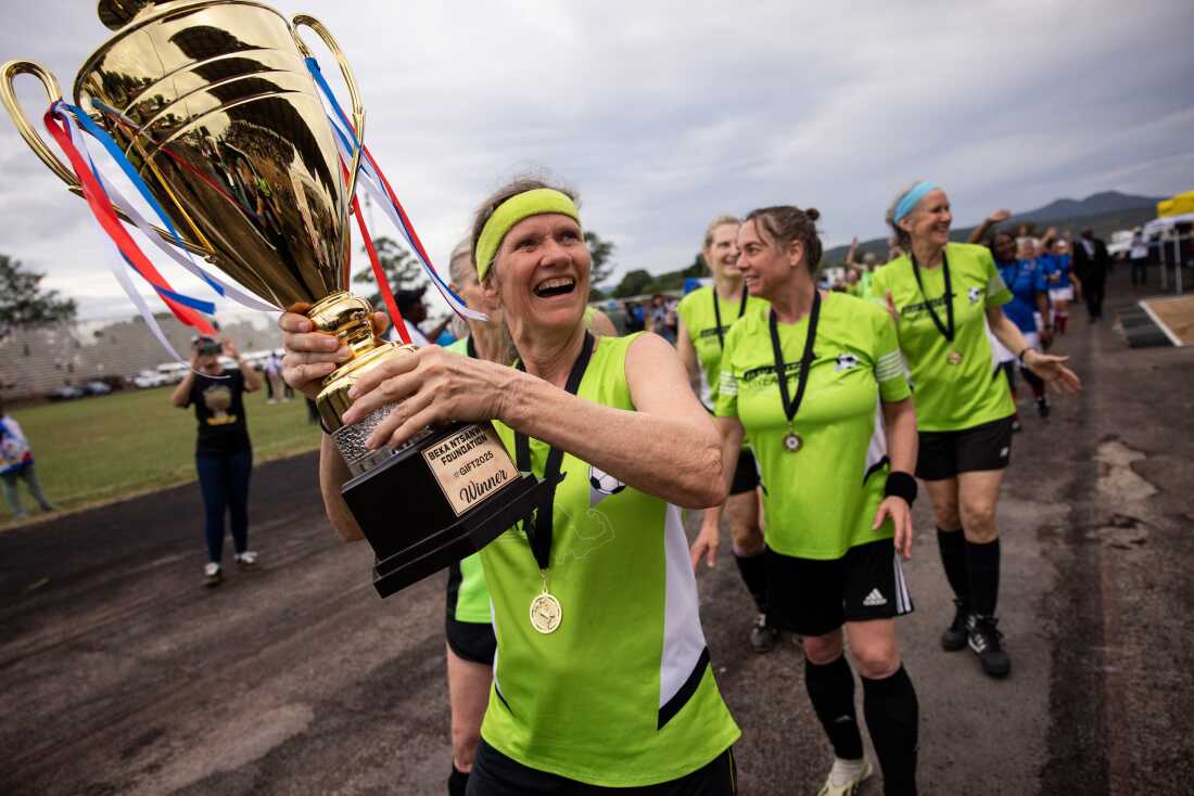 New England Boston Breakers hoist winning trophy.