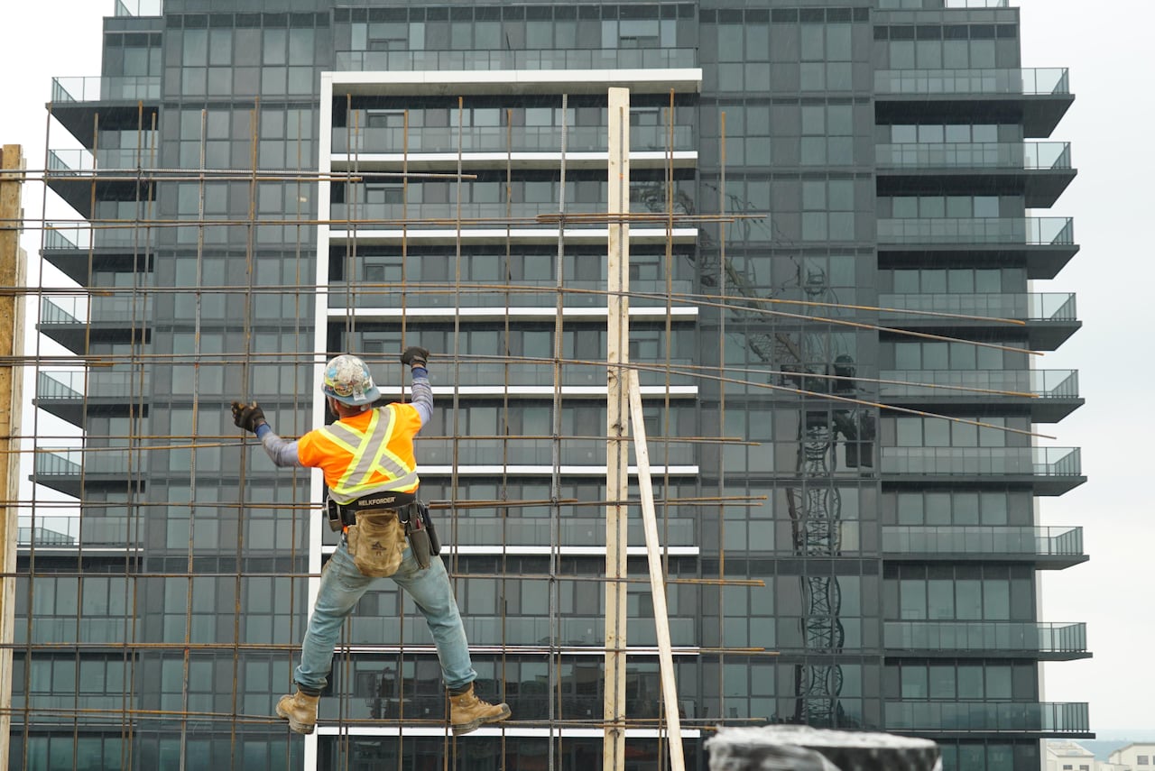 A worker ties rebar on the 29th floor of Centro's north tower. In the distance, the 40-storey south tower can be seen.