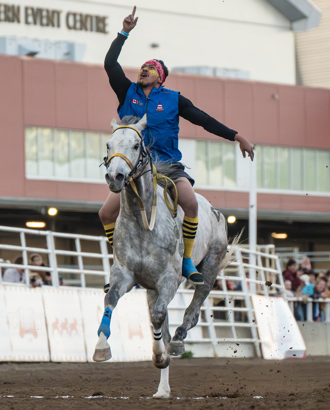 A man atop a horse racing.