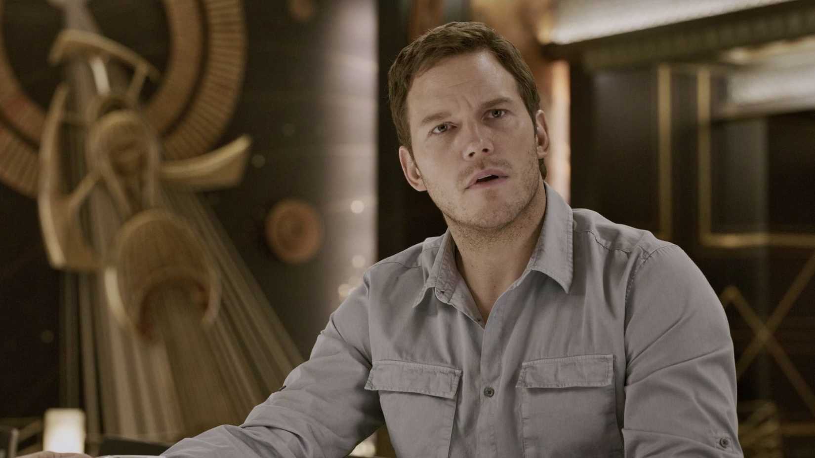 An image of Chris Pratt sitting down in a sci-fi like setting. He looks confused.