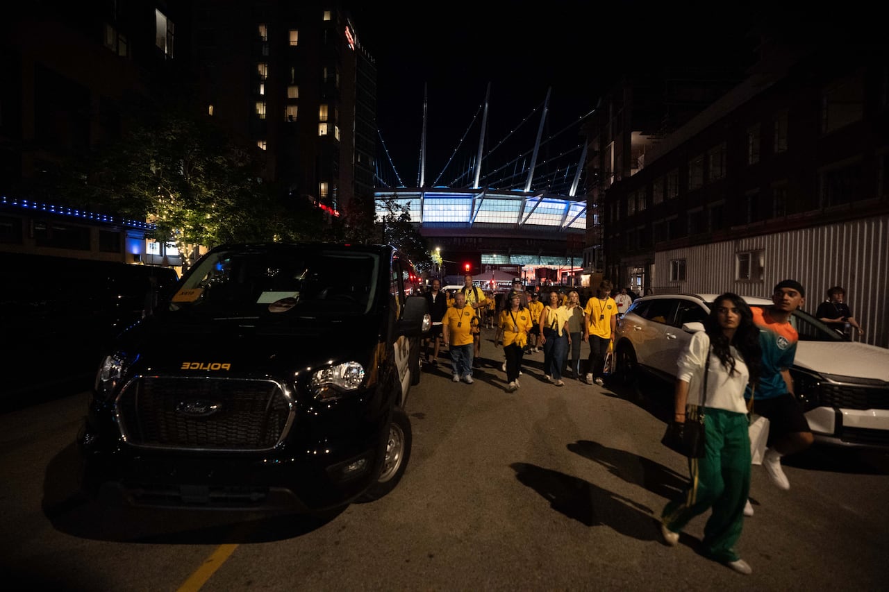 people wearing australia soccer jerseys leave a stadium