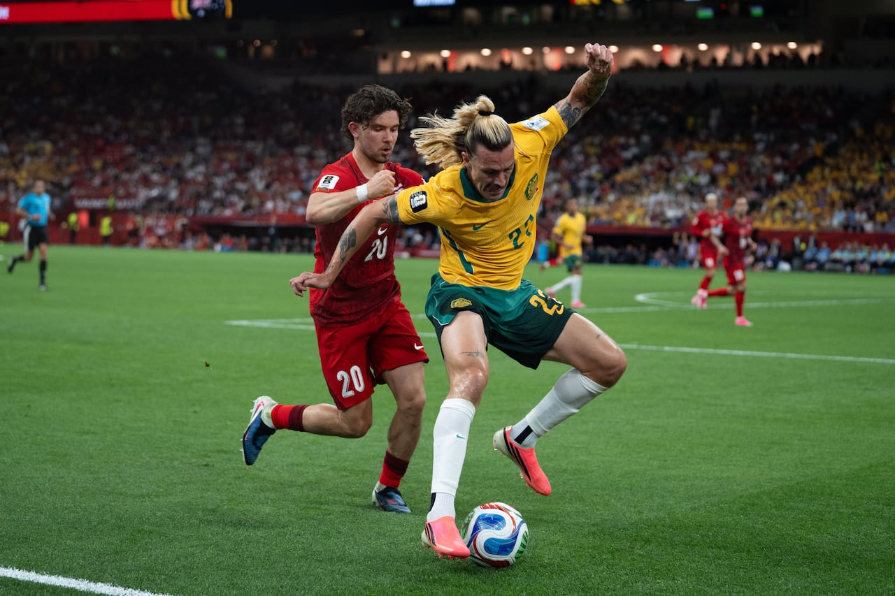 two soccer plays vy for the ball