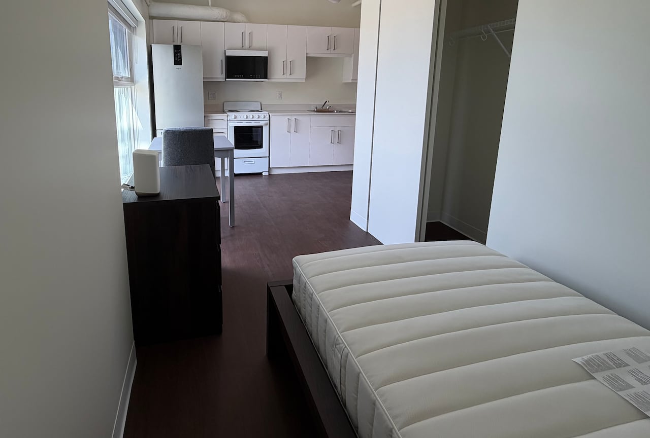 Looking inside an apartment suite with the kitchen area in the background.