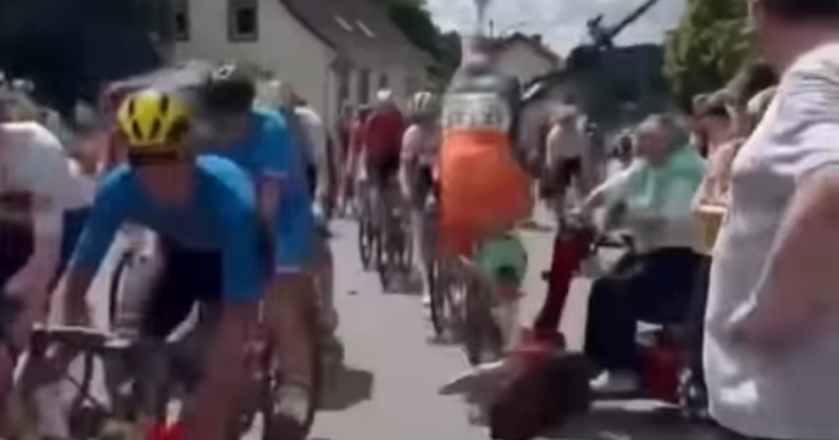 Elderly fan drives mobility scooter into peloton at junior race