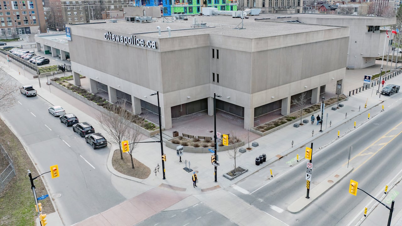 A large three-story building on a city street corner.