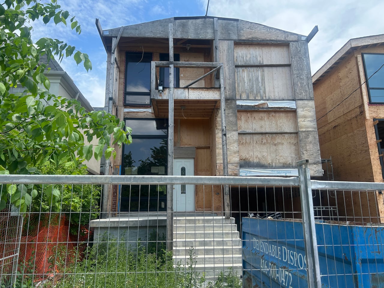 The homeowner has a city-issued permit to build a triplex on the site, however work on the Laird Drive property only happens sporadically, neighbours say.