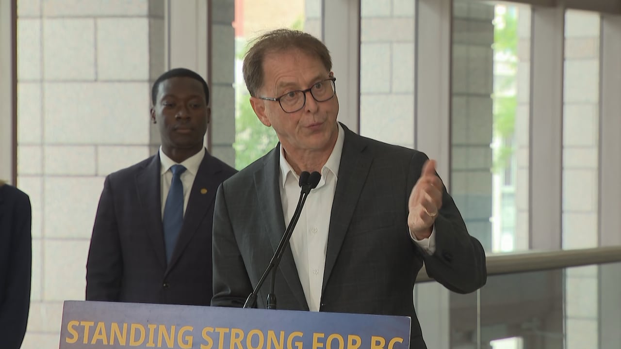 A man in a suit at a podium speaks