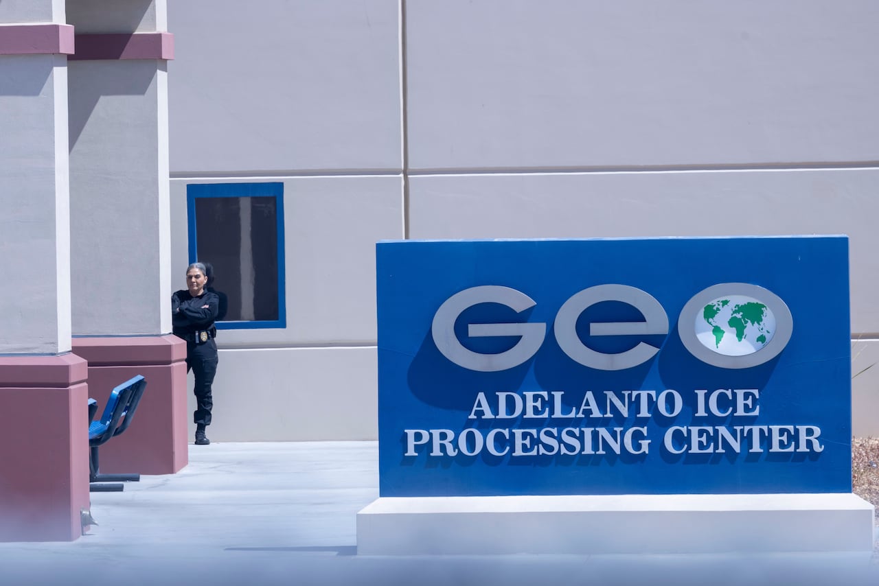 A sign outside a building reads GEO Adelanto ICE Processing Facility.
