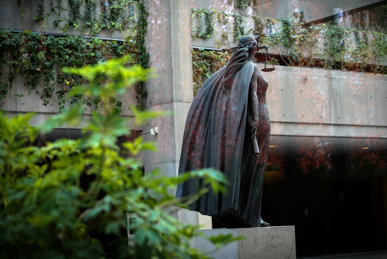 The back of a statue of Themis with the scales of justice in Vancouver Supreme Court.